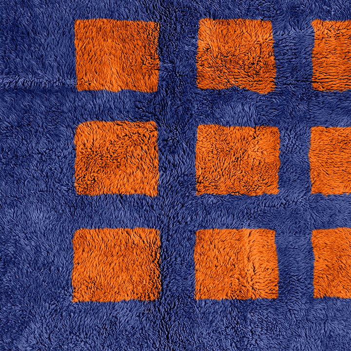 A shag Moroccan Beni Ourain Orange and Blue checkered rug