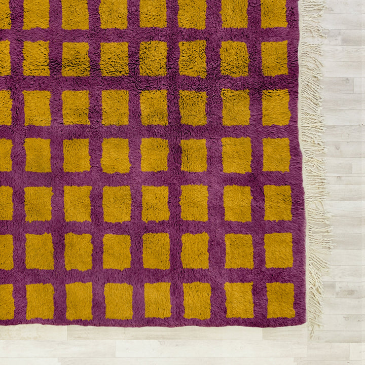 A shag Moroccan Beni Ourain Yellow and Purple checkered rug