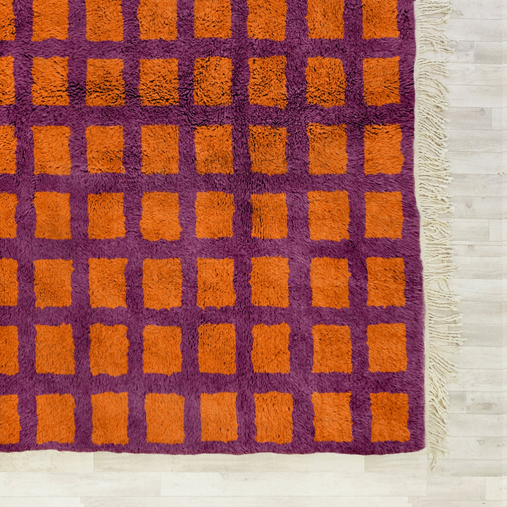 A custom Orange Bohemian Moroccan Beni Ourain checkered rug