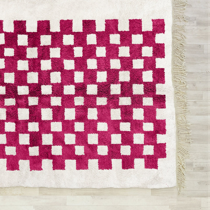 A sheepskin Beni Ourain Moroccan Red and White checkered rug