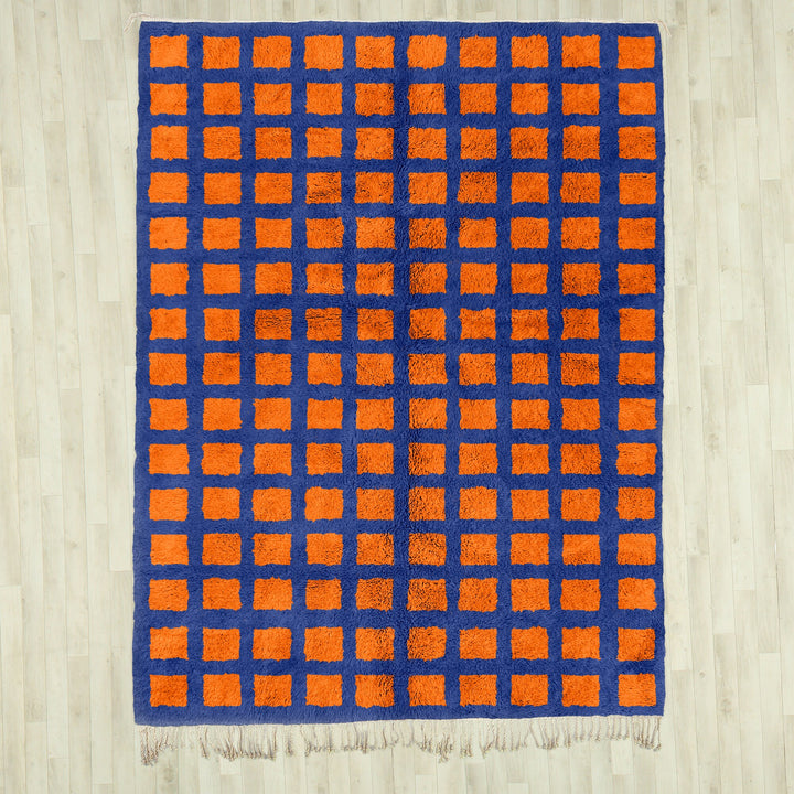 A shag Moroccan Beni Ourain Orange and Blue checkered rug