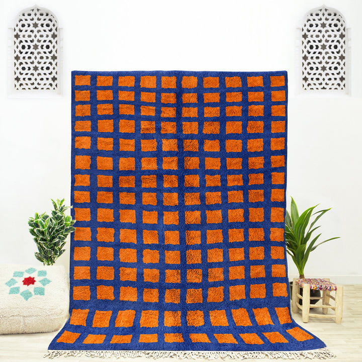 A shag Moroccan Beni Ourain Orange and Blue checkered rug