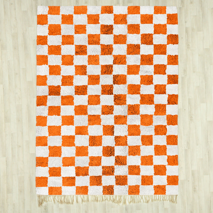 A shag Moroccan Beni Ourain Orange and White checkered rug