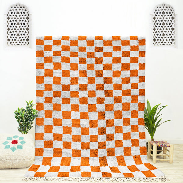 A shag Moroccan Beni Ourain Orange and White checkered rug