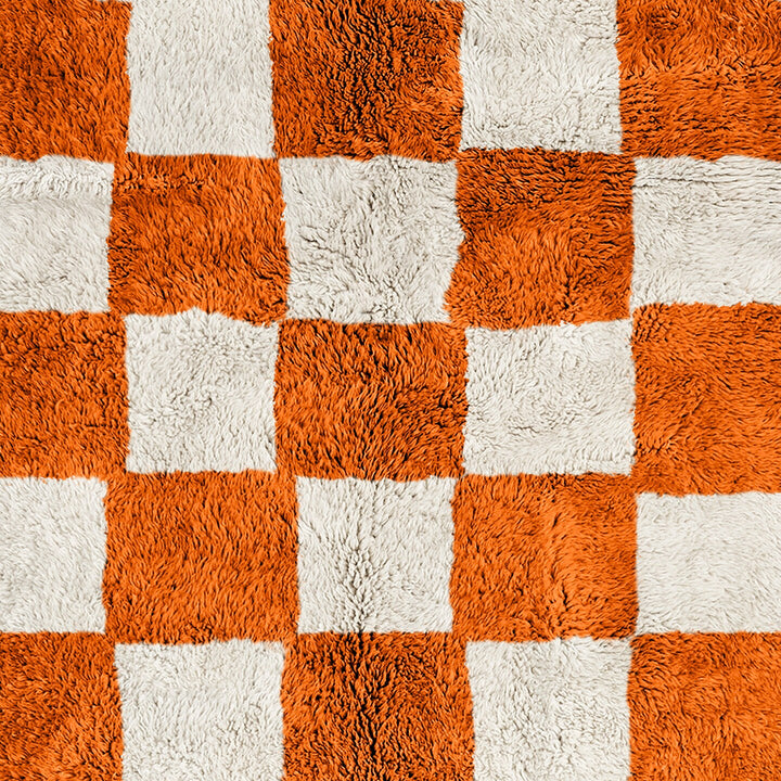 A shag Moroccan Beni Ourain Orange and White checkered rug