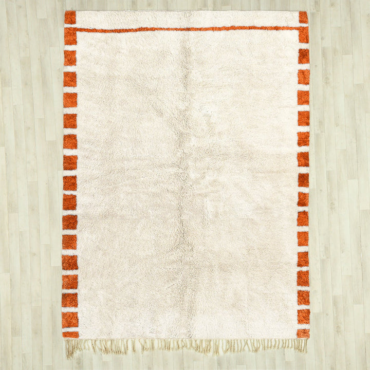 A sheepskin Beni Ourain Moroccan Orange and White checkered rug